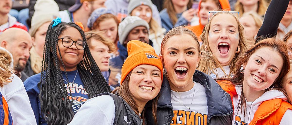 Group of smiling Carroll students with big smiles at sporting event